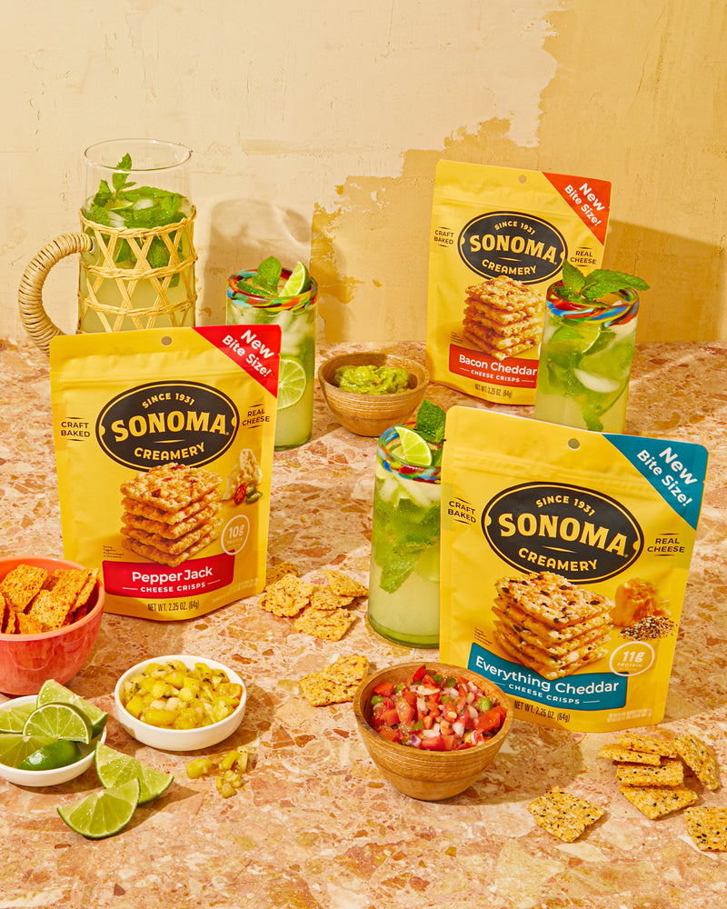A selection of Sonoma Creamery crisps on a table with drinks and salsa